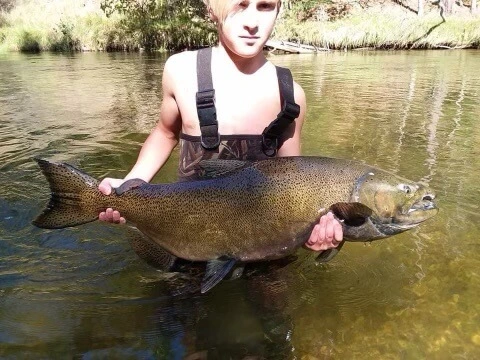 A youth shows off his caught fish