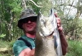 Proud fisherman with his fish