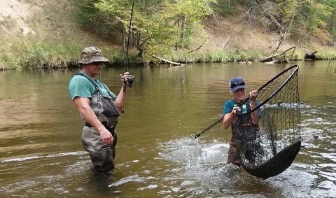 A proud father fishing with son